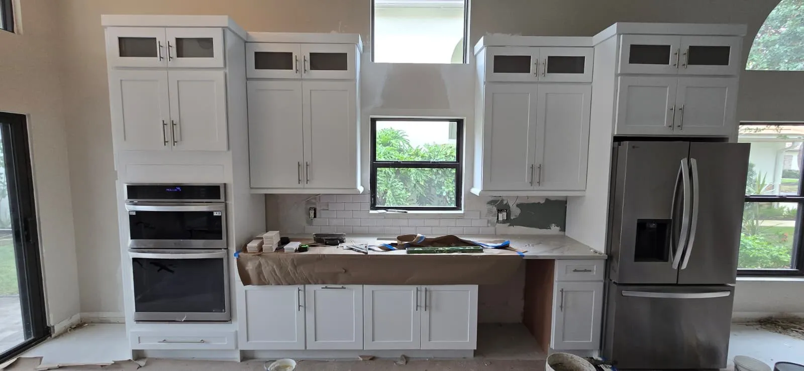 The same kitchen during install, subway tile going up