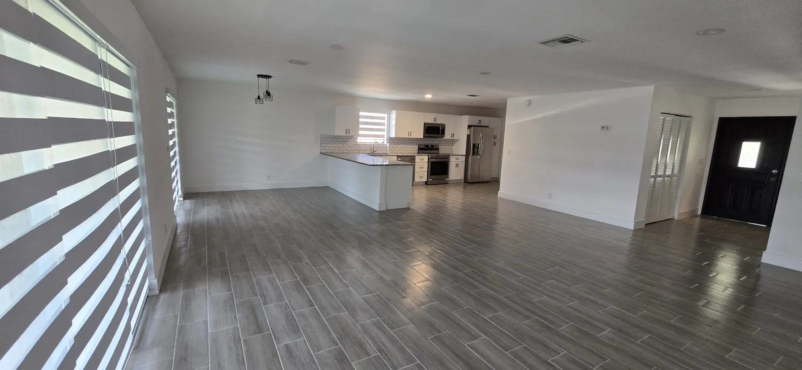 Open living area with wood-look porcelain plank floor